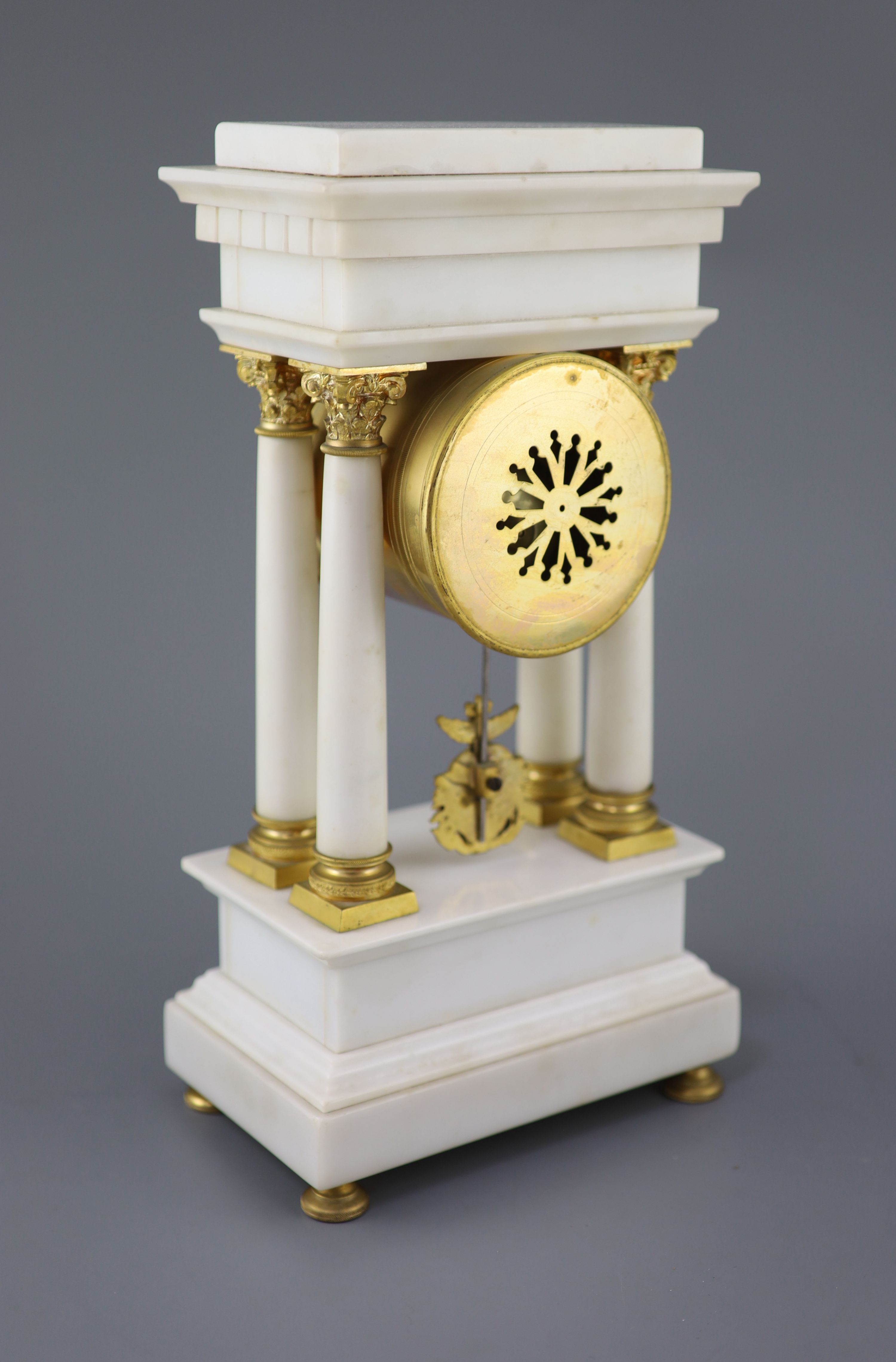 A Louis XVI style ormolu mounted white marble clock garniture, clock 14.5in. urns 13.75in.